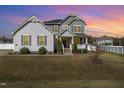 Two-story home featuring a welcoming front porch and well-manicured lawn at 1024 Jarrett Bay Rd, Willow Springs, NC 27592