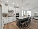 Modern kitchen featuring stainless steel appliances, a center island with seating, and elegant pendant lighting at 1425 Patchings Ln, Knightdale, NC 27545