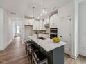 Bright and airy kitchen with white cabinetry, a quartz countertop island, and sleek stainless steel appliances at 1425 Patchings Ln, Knightdale, NC 27545