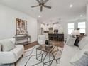 Open-concept living room showcasing contemporary decor, hardwood floors, and seamless flow to the kitchen at 1425 Patchings Ln, Knightdale, NC 27545