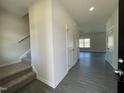 Inviting entryway features wood-look flooring and staircase leading to the upper level at 180 Deodora Ln, Cameron, NC 28326