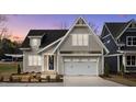 Charming home featuring a two-car garage and inviting craftsman-style design at 418 S Cross St, Youngsville, NC 27596