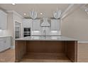 Spacious kitchen featuring a large island, modern appliances, and elegant lighting at 418 S Cross St, Youngsville, NC 27596