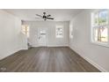 Unfurnished living room with ample natural light and modern wood-look flooring throughout at 50 N Rowsham Pl, Smithfield, NC 27577