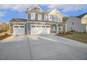 Attractive two-story home with stone accents and an attached two-car garage on a concrete driveway at 611 Highview Dr, Benson, NC 27504
