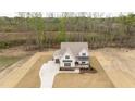 Beautiful home on a large lot, showcasing manicured landscaping and a long, winding driveway at 8624 Dukes Lake Rd, Zebulon, NC 27597