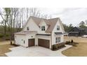 Spacious three-car garage, with an expansive driveway, offering ample parking and storage at 8624 Dukes Lake Rd, Zebulon, NC 27597