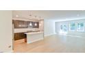 Open concept living space featuring modern kitchen and hardwood floors leading to bright living area at 140 Norwell Ln, Pittsboro, NC 27312