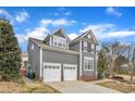 Attractive two-story residence featuring gray siding, dormers, and a two-car garage at 10877 Bedfordtown Dr, Raleigh, NC 27614