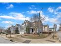 Neighborhood street view showcases a gray two-story home with an attached two-car garage at 10877 Bedfordtown Dr, Raleigh, NC 27614