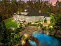 Inviting pool and spa surrounded by lush landscaping and stonework at 110 Bywater Way, Chapel Hill, NC 27516