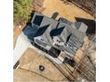 An aerial view reveals this home's brick and siding design, complemented by a driveway and manicured landscaping at 1226 Red Cedar Ct, Youngsville, NC 27596