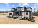 Beautiful two-story home featuring stone accents, a covered porch, manicured landscaping, and ample curb appeal at 30 Hartwood Ln, Youngsville, NC 27596