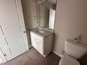 Bathroom with granite vanity, single sink and toilet at 48 Silver Ct, Smithfield, NC 27577