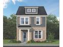 Charming two-story home with gray siding, brick facade, complemented by well-manicured landscaping, and a inviting blue front door at 937 Alma Railway Dr # 555, Wake Forest, NC 27587