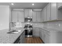 Featuring gray cabinets, granite countertops, and stainless steel appliances at 937 Alma Railway Dr # 555, Wake Forest, NC 27587