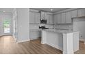 A kitchen featuring gray cabinets, granite countertops, and stainless steel appliances at 937 Alma Railway Dr # 555, Wake Forest, NC 27587