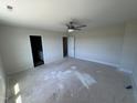 Spacious bedroom with carpet, a ceiling fan and two doors leading to a bathroom and closet at 195 Sawyer Mill Dr, Dunn, NC 28334