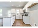 Bright kitchen featuring white cabinets, stainless steel appliances, granite counters, and a center island at 195 Sawyer Mill Dr, Dunn, NC 28334