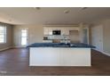 Bright kitchen with island, white cabinets and stainless steel microwave at 47 Silver Ct, Smithfield, NC 27577