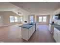 Spacious living room with large windows and a central kitchen island at 47 Silver Ct, Smithfield, NC 27577