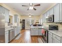 Eat-in kitchen with grey cabinets, granite countertops, stainless appliances and hardwood floors at 143 Rawhide Dr, Louisburg, NC 27549