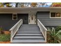Steps leading to a white front door with sidelights and a white railing at 2600 Wade Ave, Raleigh, NC 27607