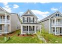 Attractive two-story house with gray siding, black shutters, and a well-maintained lawn and garden at 276 White Oak Garden Way # 210, Garner, NC 27529