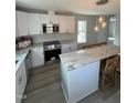 Modern kitchen featuring white cabinets, stainless steel appliances, and a large island at 530 Lansing St, Raleigh, NC 27610