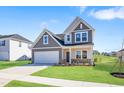 Charming two-story home featuring a two-car garage and a well-manicured front yard at 604 Spellbrook Rd, Zebulon, NC 27597