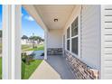 Inviting covered front porch with brick accents and ample natural light at 604 Spellbrook Rd, Zebulon, NC 27597