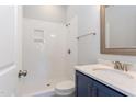 Modern bathroom with a tiled shower, marble countertop, and sleek fixtures at 1112 Armsleigh Ct, Raleigh, NC 27603