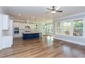 Open-concept kitchen with a large island, stainless steel appliances, and hardwood flooring at 1112 Armsleigh Ct, Raleigh, NC 27603