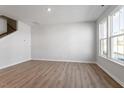 Open-concept living area with wood floors and a staircase in view at 255 Chesapeake Commons St # 90, Garner, NC 27529