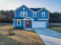 A captivating two-story residence boasts a well-maintained yard and an attached garage at 316 Robert Howe Dr, Fuquay Varina, NC 27526