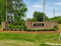 Stone entrance sign to the Brannon Manor community, surrounded by landscaped greenery and a lush green lawn at 20 Water Willow Ln, Zebulon, NC 27597