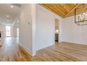 Bright dining room featuring a wooden ceiling, hardwood floors, and modern light fixture at 2401 Terri Creek N Dr # 08, Fuquay Varina, NC 27526