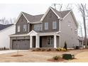 Attractive two-story home with a gray exterior, two car garage, and nicely landscaped yard at 2401 Terri Creek N Dr # 08, Fuquay Varina, NC 27526