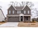 Beautiful two-story home featuring a gray exterior, double garage, and inviting front porch at 2401 Terri Creek N Dr # 08, Fuquay Varina, NC 27526