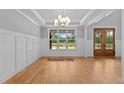 Bright dining room featuring hardwood floors, large windows, and decorative trim at 5100 Grist Stone Way, Youngsville, NC 27596