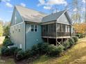 Back exterior showing a screened in porch with stairs leading to a well manicured yard at 181 Colonial Ridge Dr, Pittsboro, NC 27312
