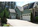 Exterior view of the home's three-car garage, offering ample parking and storage space at 181 Colonial Ridge Dr, Pittsboro, NC 27312