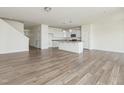 Bright and airy living space featuring wood floors and an open concept kitchen with pendant lighting at 579 Winding Creek Dr, Lillington, NC 27546