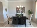 Elegant dining room with modern chandelier, neutral walls, and ample space for entertaining at 60 Falls Of The Cape Dr, Lillington, NC 27546