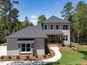 Charming two-story home with neutral siding and mature landscaping and walkway at 103 Brandy Ml, Pittsboro, NC 27312
