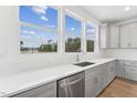 Bright kitchen featuring white subway tile backsplash and stainless steel appliances at 444 Billingshurst Way, Knightdale, NC 27545