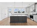 Open concept kitchen with island and stainless steel appliances at 444 Billingshurst Way, Knightdale, NC 27545