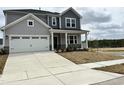 Charming two-story home with a two-car garage and beautifully landscaped front yard at 657 Sun Meadow Dr, Wake Forest, NC 27587