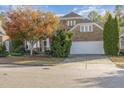 Charming brick home with a two-car garage, complemented by mature trees and manicured landscaping at 719 Allforth Pl, Cary, NC 27519