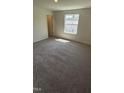Bright bedroom with carpet and a large window, perfect for relaxation and comfort at 1103 Mountain Crown St, Durham, NC 27703